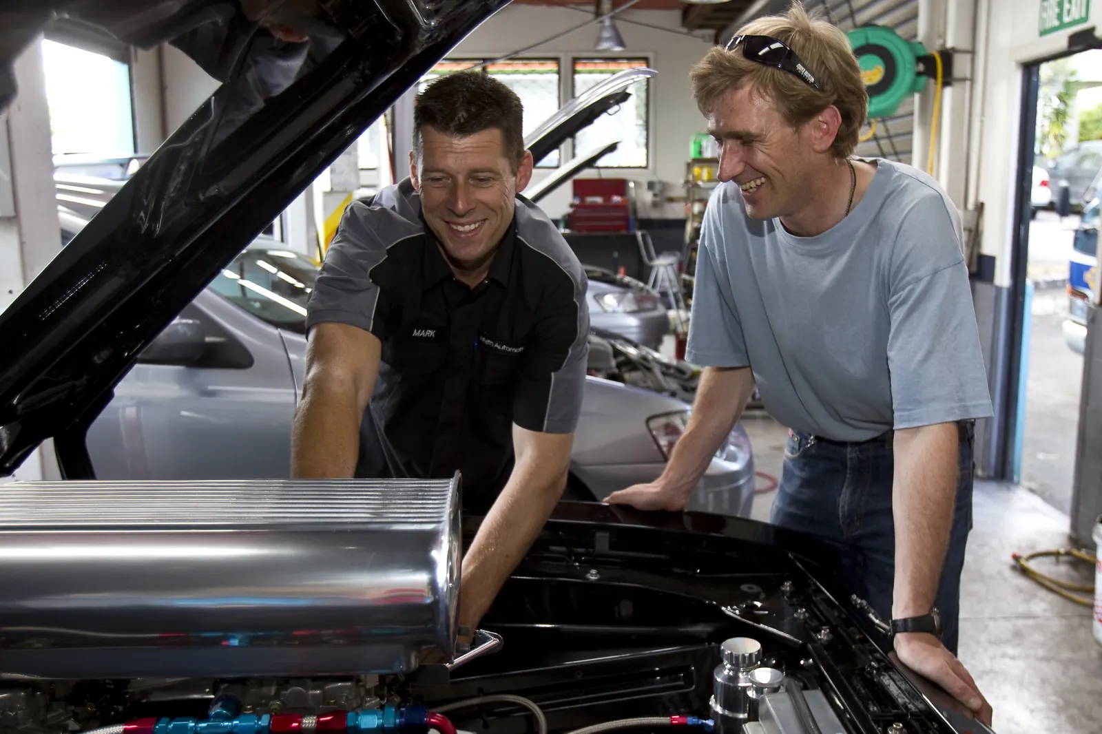 Mark and a customer at an open engine bay